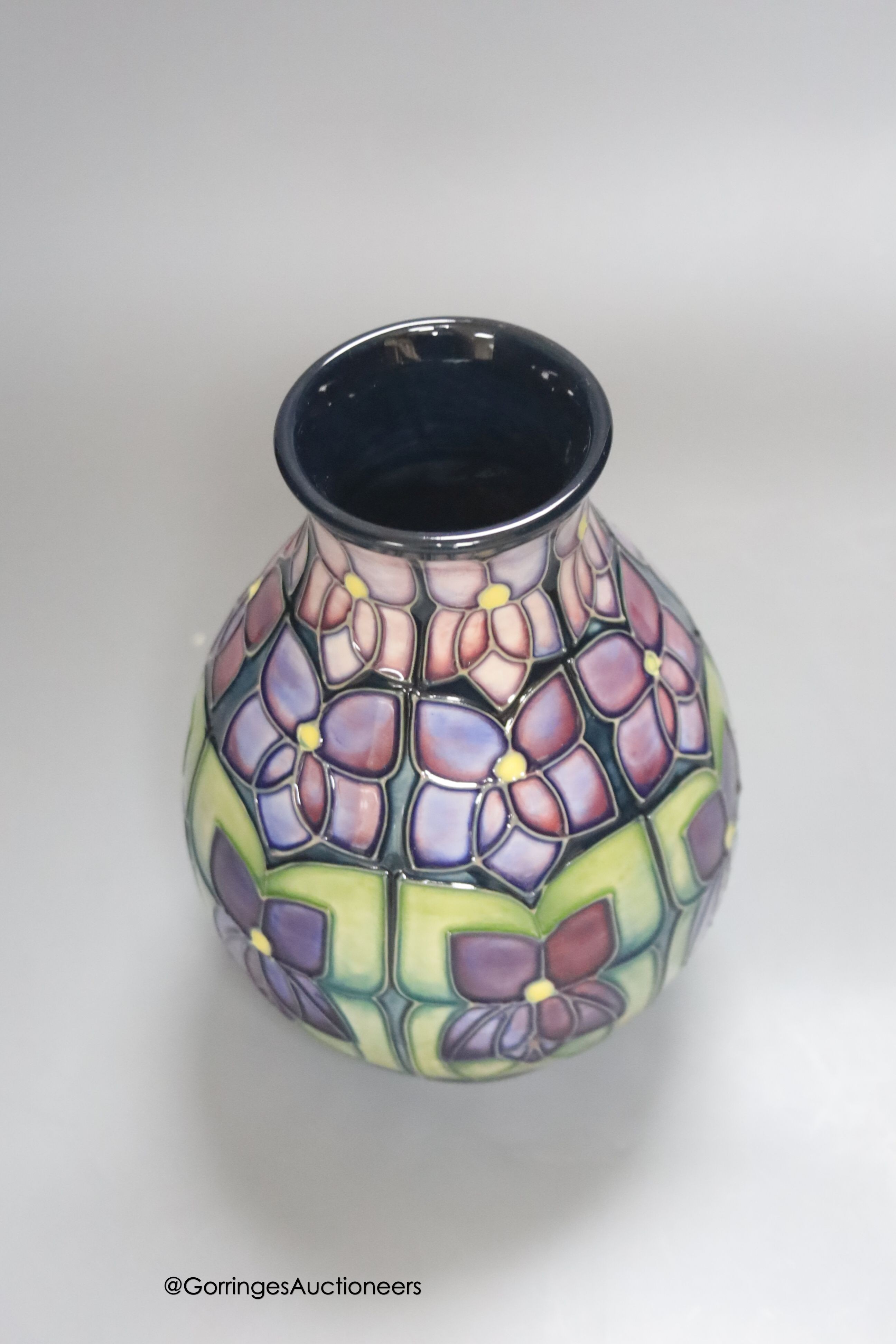 A Moorcroft Violets pattern vase, height 19cm